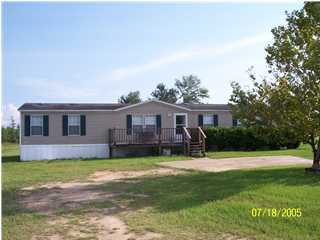 a house view with a sitting space and garden