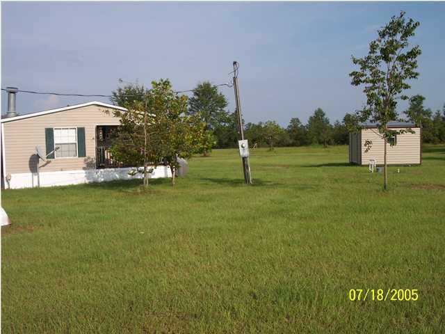 5097 Keyser Mill Road Baker, FL 32531 - Photo 2 of 10 a view of a house with a yard