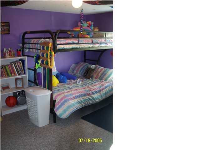 5097 Keyser Mill Road Baker, FL 32531 - Photo 5 of 10 a bed room with a bed and a book shelf