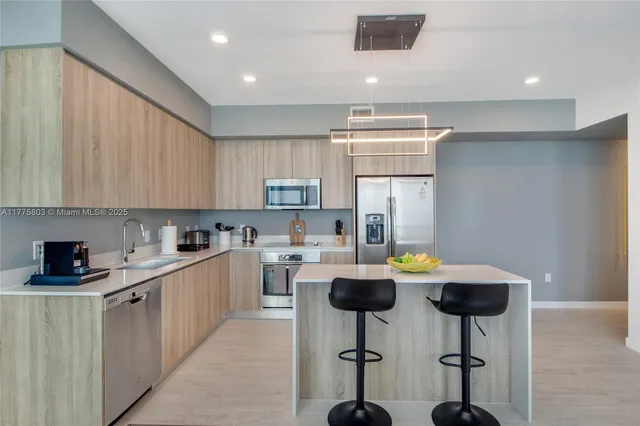 a kitchen with a sink a stove cabinets and counter space