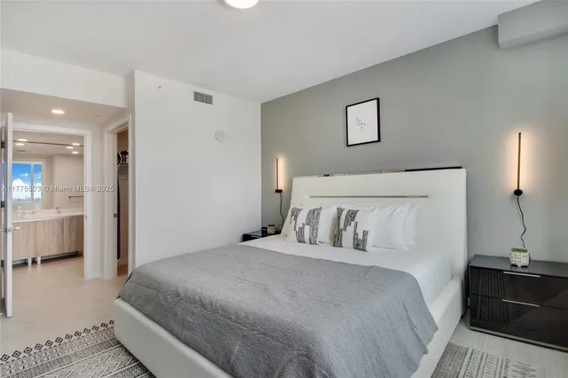 a bedroom with a bed and a view of bathroom