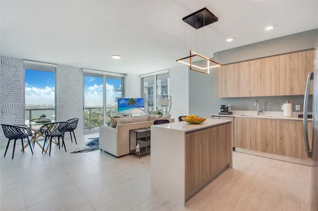 a kitchen filled with a white cabinets and chairs