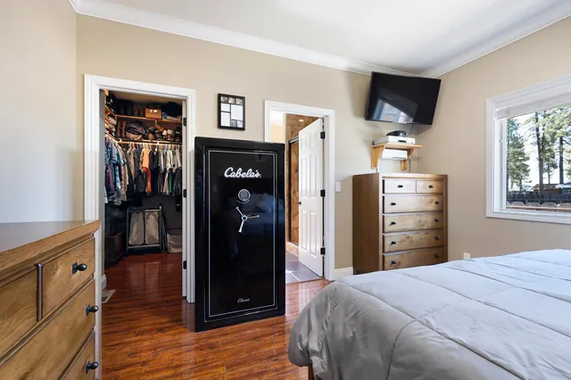 a bedroom with a bed and a television