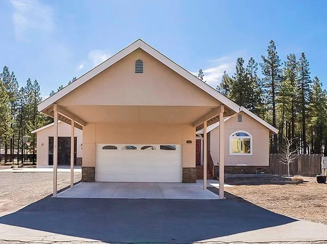 a view of a house with a yard and garage