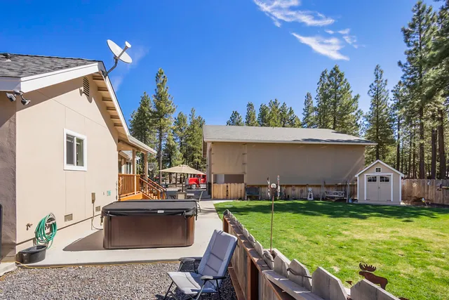 a view of a house with backyard and sitting area