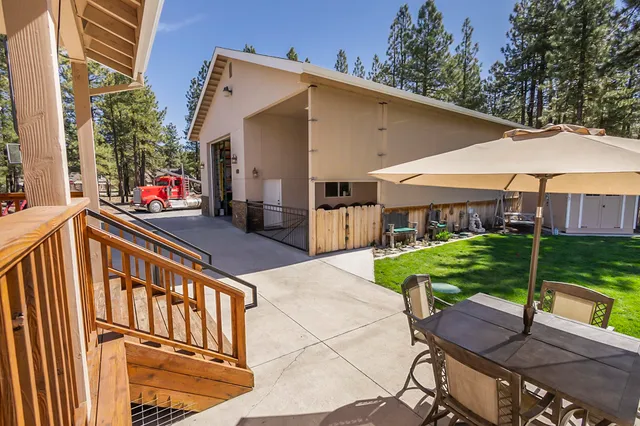 a view of a house with backyard and sitting area