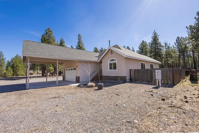 a view of a house with a snow in the background