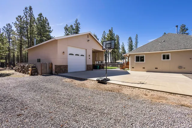 a view of a house with snow on the side of the road