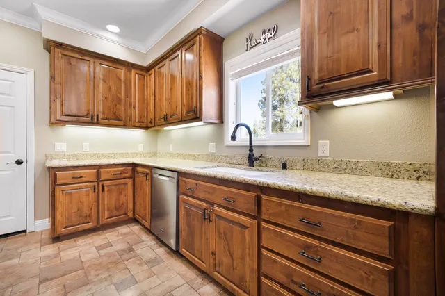 a kitchen with sink and cabinets