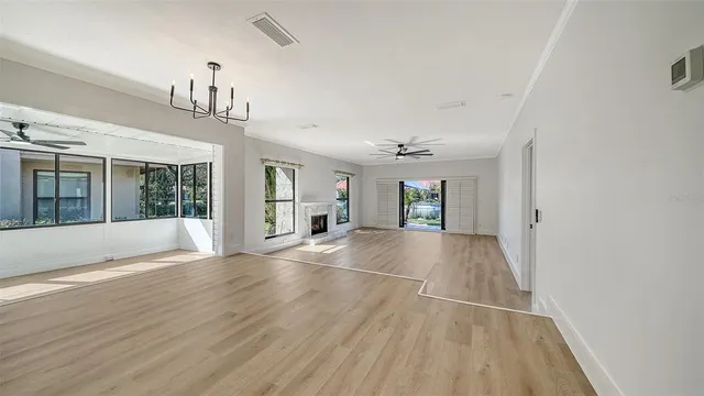 a view of an empty room with window and fire place