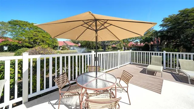 a view of a patio with table and chairs potted plants with wooden floor