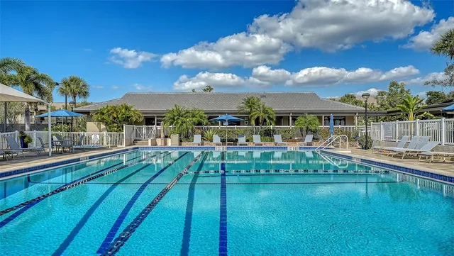 a view of a balcony with chairs and wooden floor