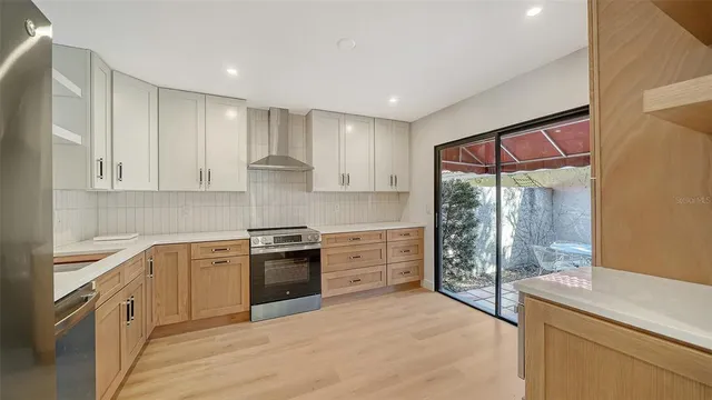 a kitchen with a stove a sink and a refrigerator
