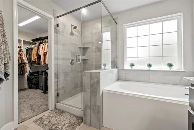 a bathroom with a bathtub and a shower