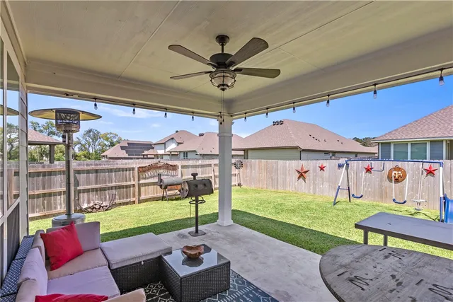 a view of a patio with a table and chairs