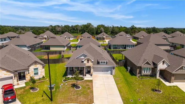 an aerial view of residential houses with outdoor space