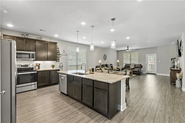 a large kitchen with a table and chairs