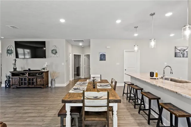 a dining room with furniture and wooden floor