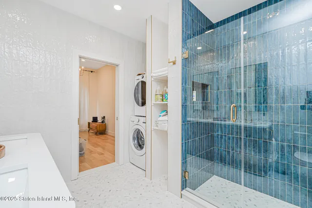 a large white kitchen with a refrigerator a stove a oven and a sink with wooden floor