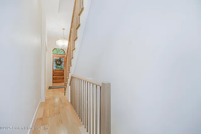 a view of staircase with wooden floor and a rug