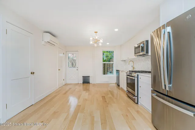 a kitchen with kitchen island cabinets and chairs