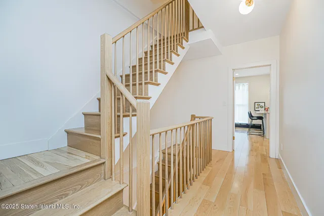 a view of a kitchen with a sink wooden floor and windows