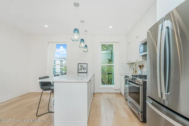 a view of a house with a wooden deck
