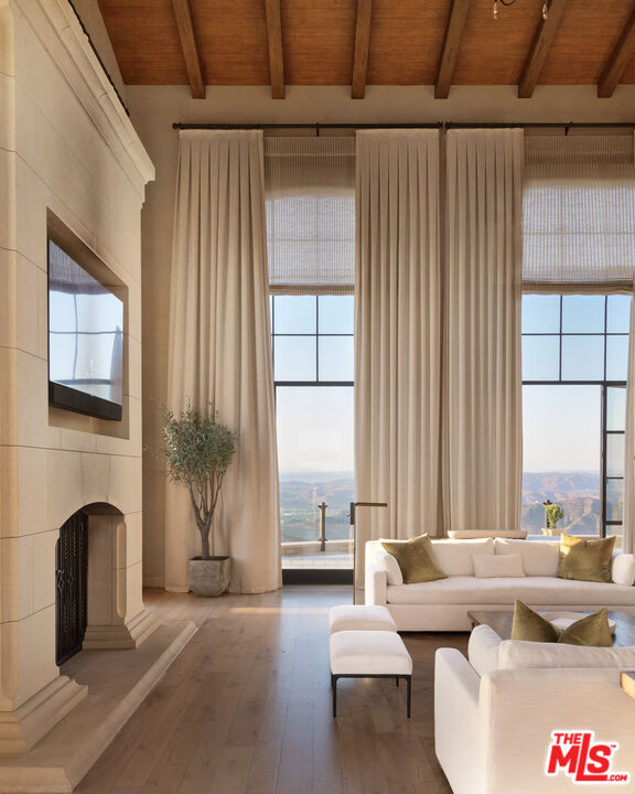 340 Kanan Dume Road Malibu, CA 90265 - Photo 15 of 57 a living room with fireplace furniture and a floor to ceiling window