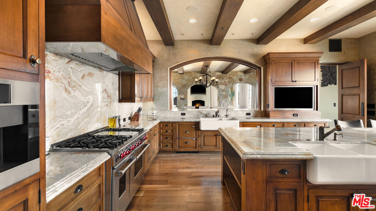 340 Kanan Dume Road Malibu, CA 90265 - Photo 18 of 57 a kitchen with stainless steel appliances granite countertop a sink and a stove