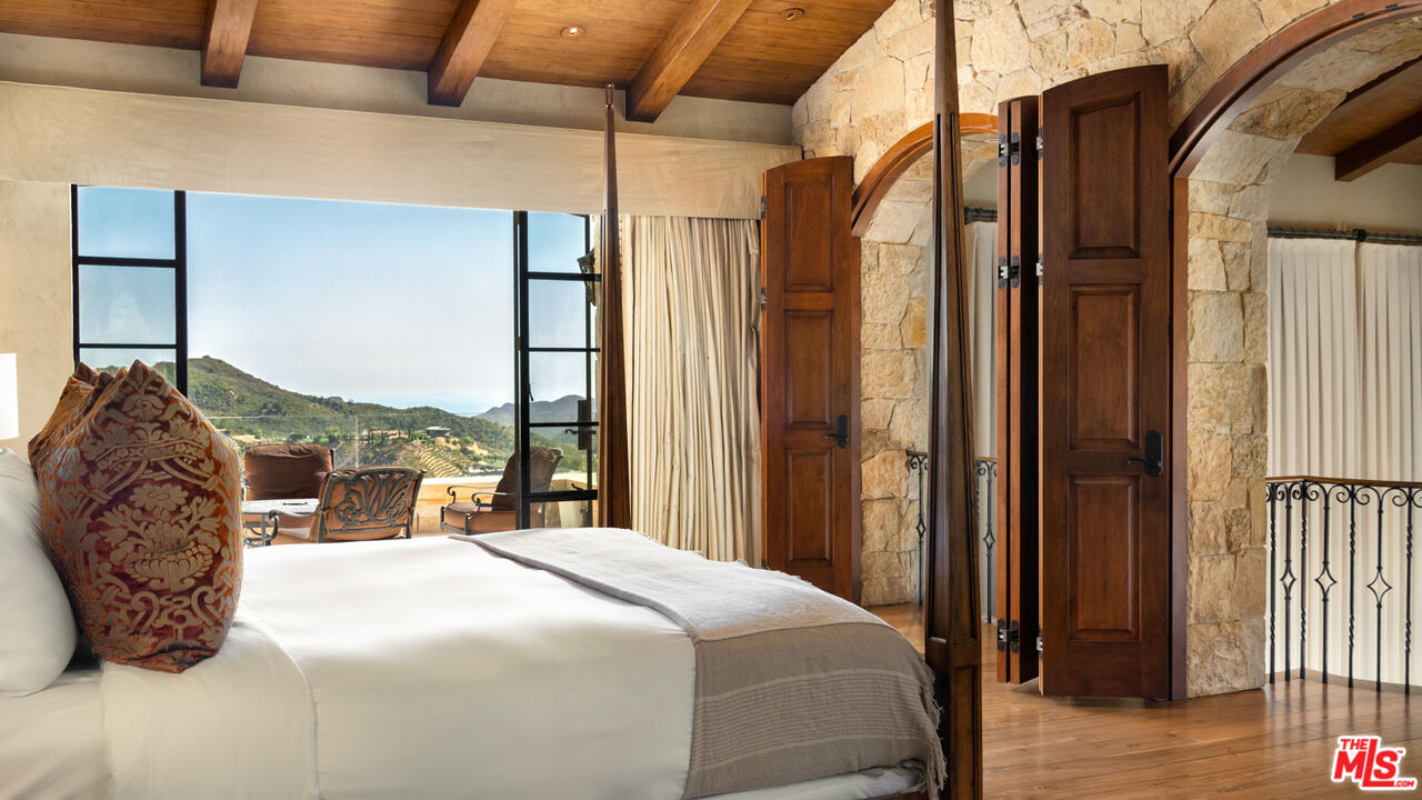 340 Kanan Dume Road Malibu, CA 90265 - Photo 22 of 57 a bedroom with a bed and a large window