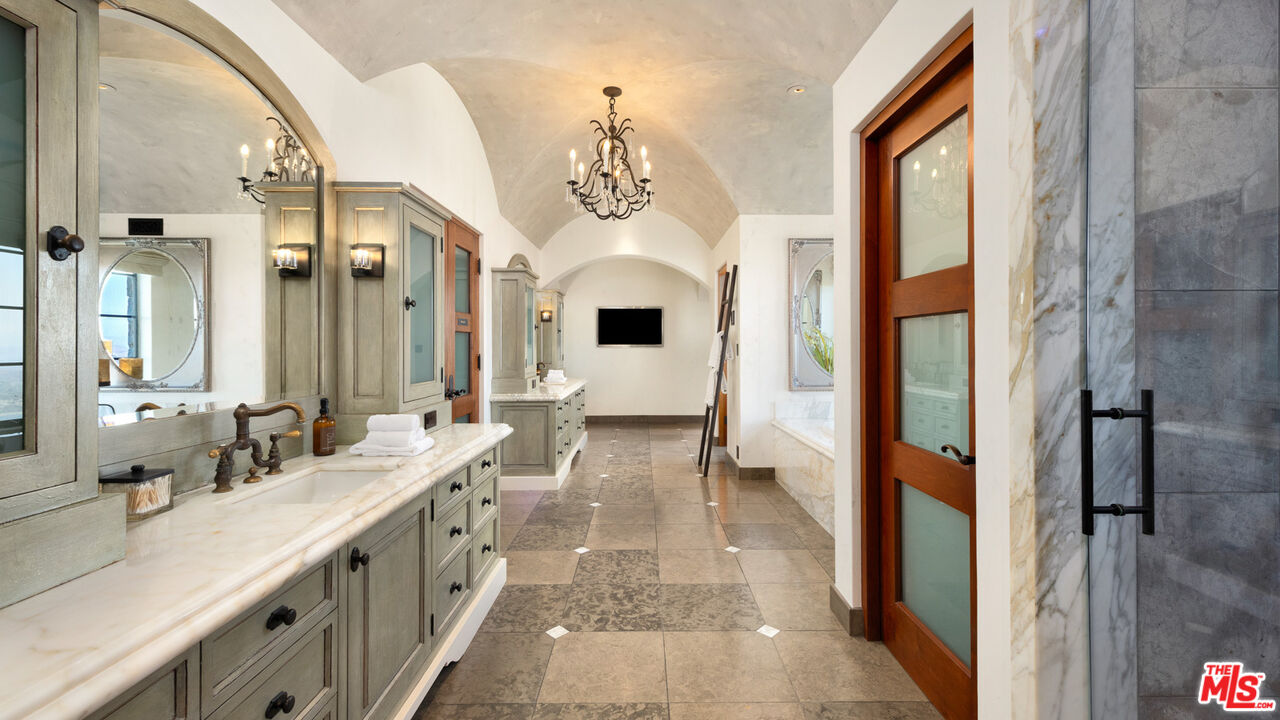 340 Kanan Dume Road Malibu, CA 90265 - Photo 24 of 57 a en suite bathroom with a double vanity sink and a mirror