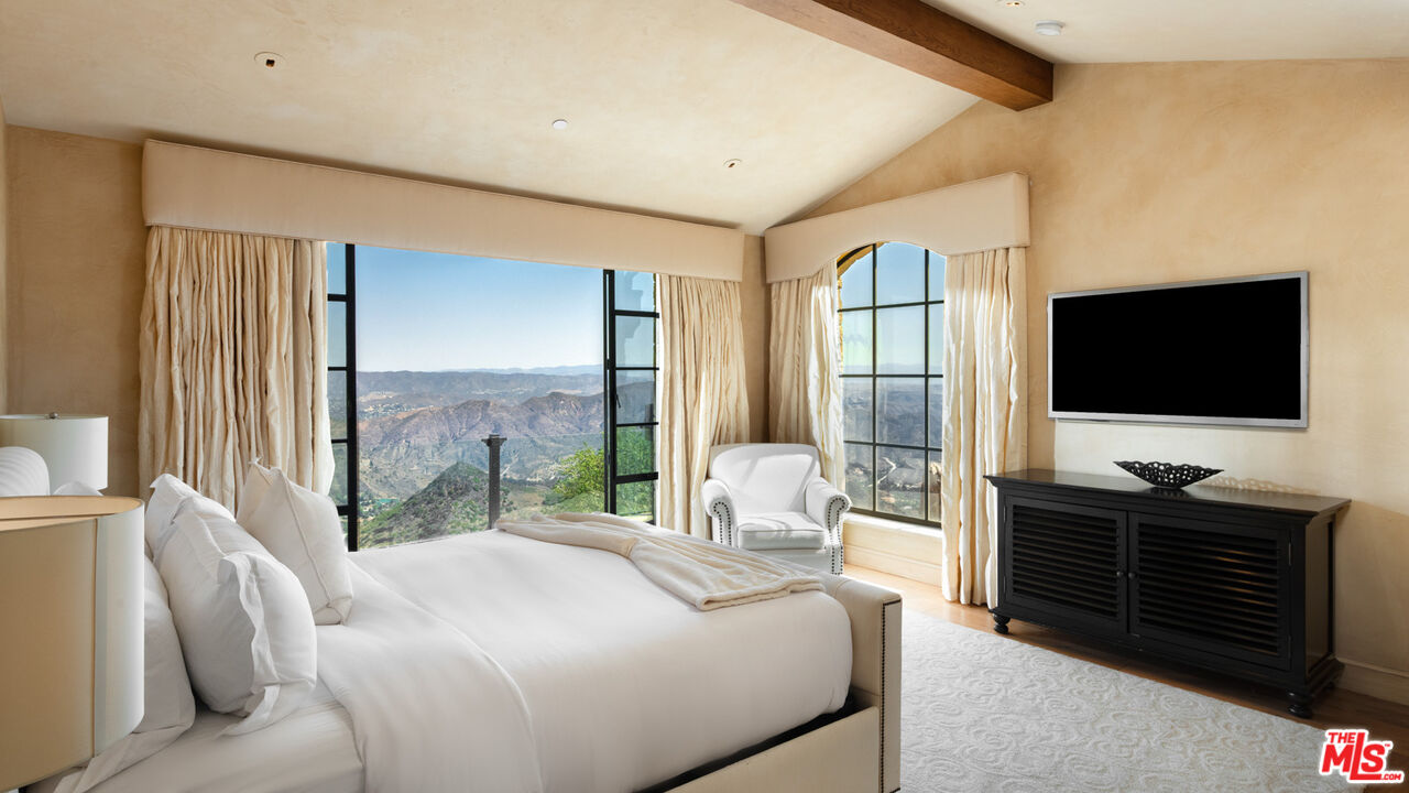 340 Kanan Dume Road Malibu, CA 90265 - Photo 36 of 57 a bedroom with furniture and a flat screen tv