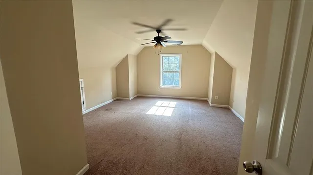 a view of a livingroom with a window and wooden floor