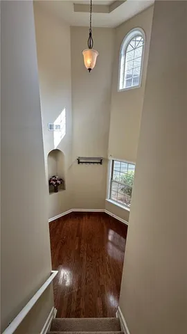 a view of hallway with window and stairs