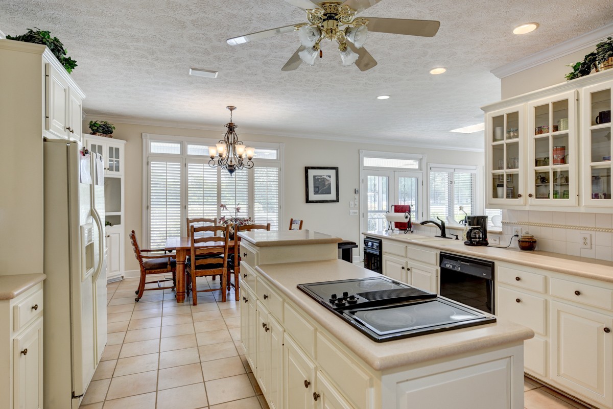 519 Maple Hill Road Lebanon, TN 37087 - Photo 16 of 49 a kitchen with a stove a refrigerator and a dining table