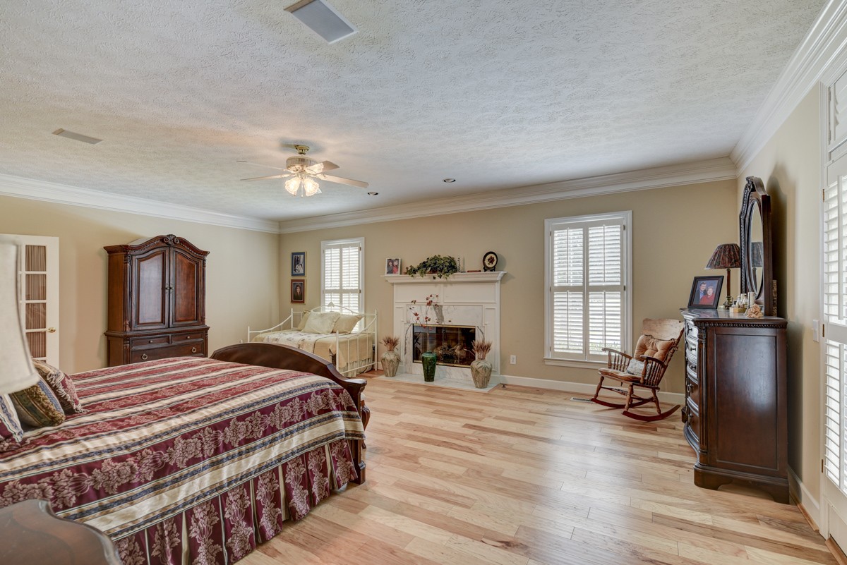 519 Maple Hill Road Lebanon, TN 37087 - Photo 20 of 49 a bedroom with a bed and a fireplace