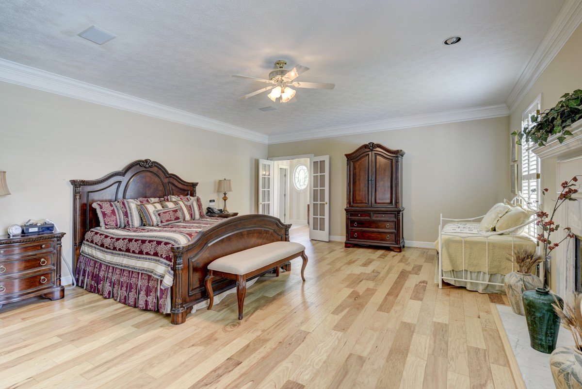 519 Maple Hill Road Lebanon, TN 37087 - Photo 21 of 49 a bedroom with a bed and a chandelier