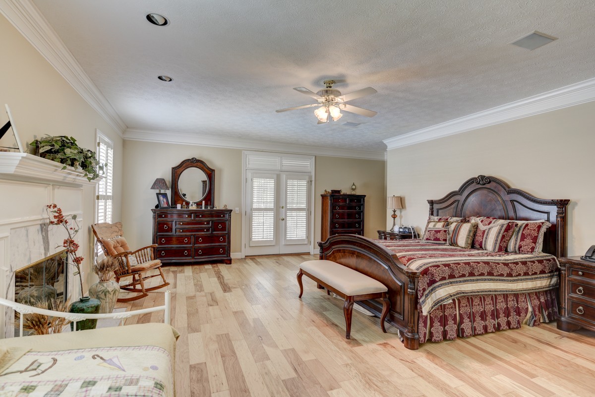 519 Maple Hill Road Lebanon, TN 37087 - Photo 22 of 49 a bedroom with a bed and a chandelier