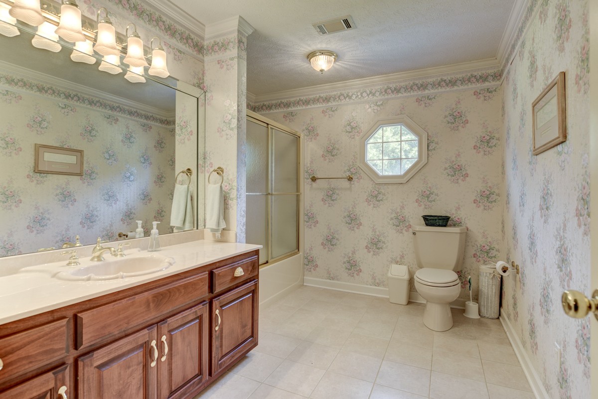 519 Maple Hill Road Lebanon, TN 37087 - Photo 31 of 49 a bathroom with a sink a toilet and a large mirror