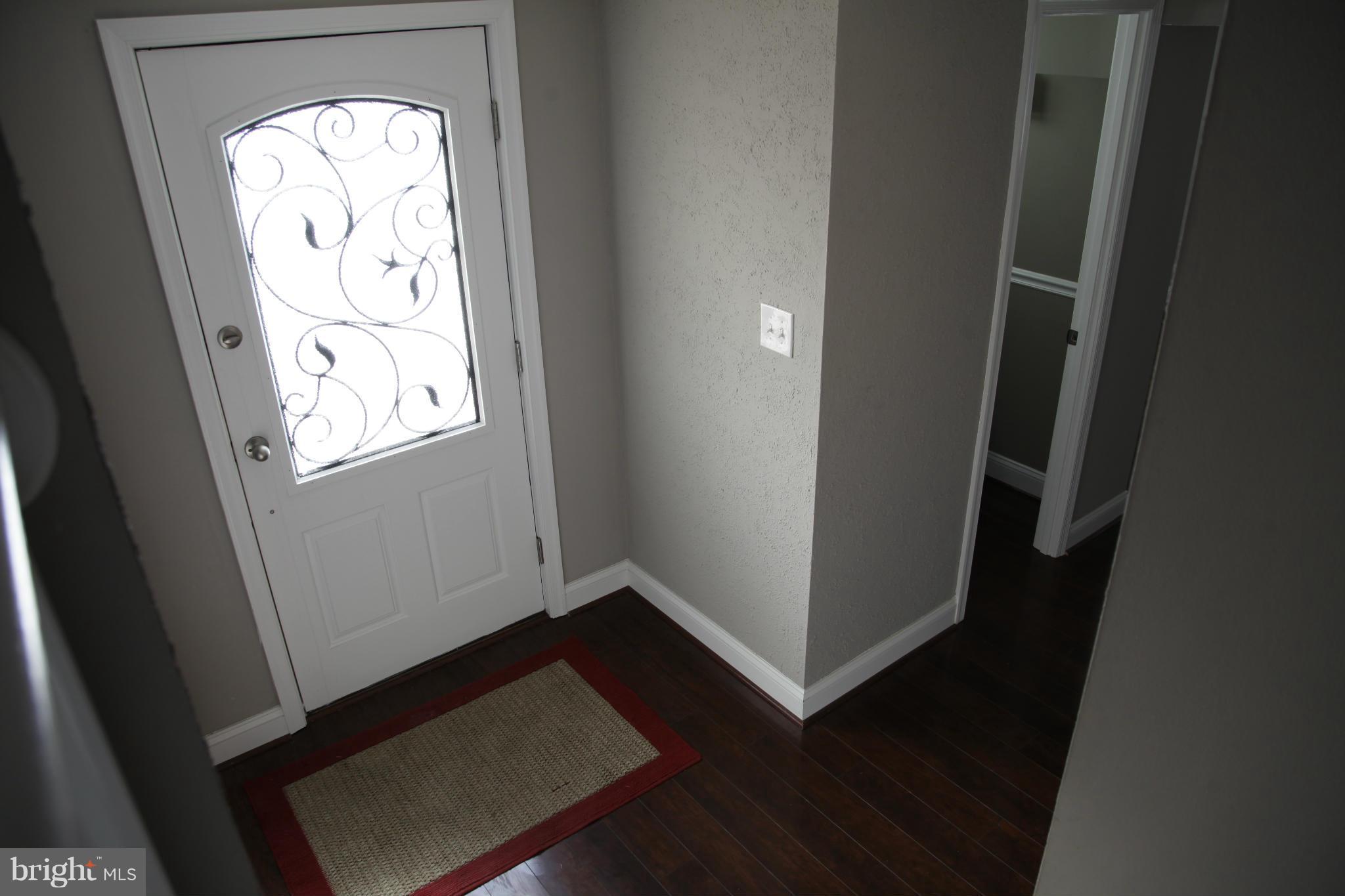 3344 Ripple Road Windsor Mill, MD 21244 - Photo 2 of 30 an entryway with wooden floor and a window