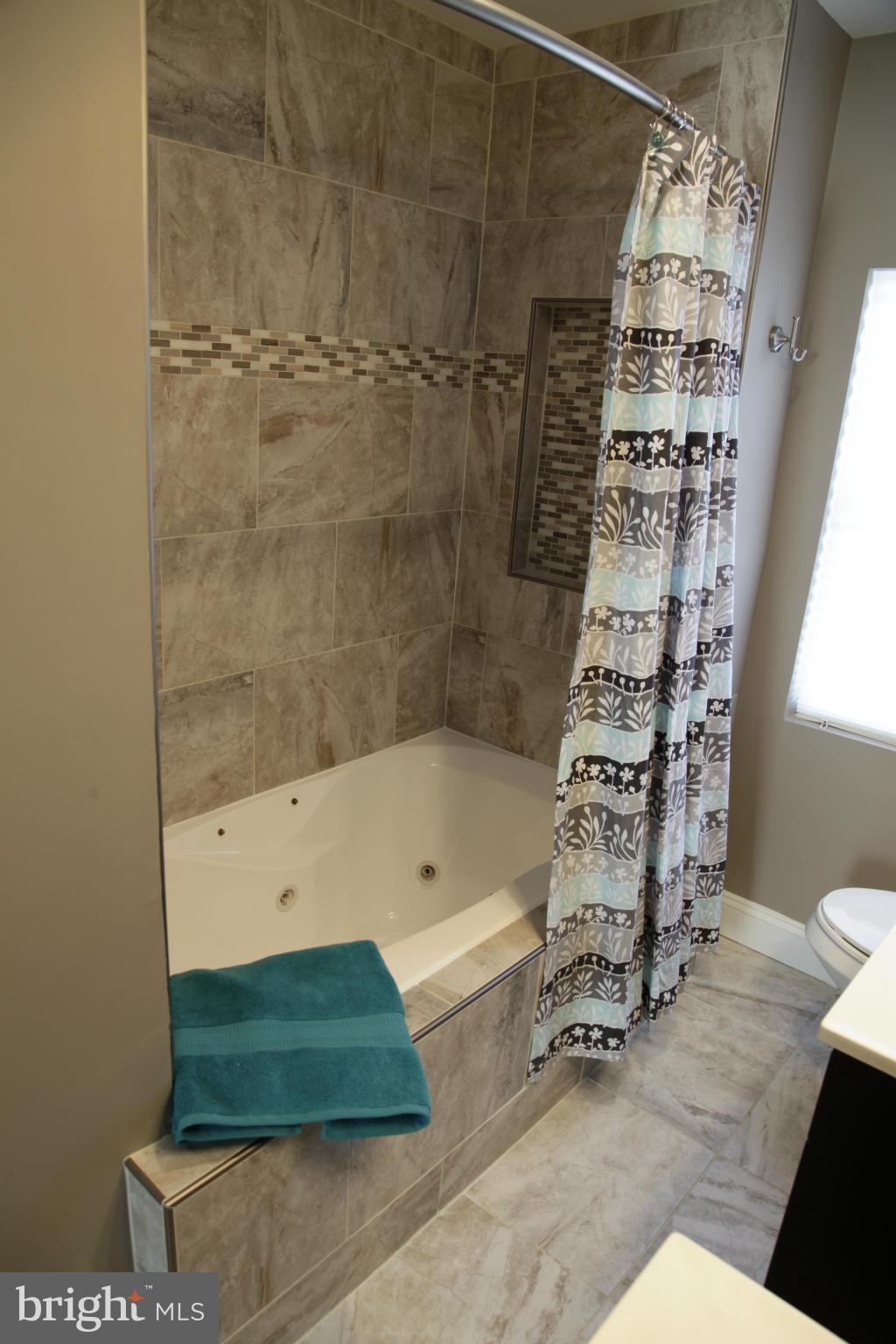 3344 Ripple Road Windsor Mill, MD 21244 - Photo 15 of 30 a bathroom with a bathtub and shower