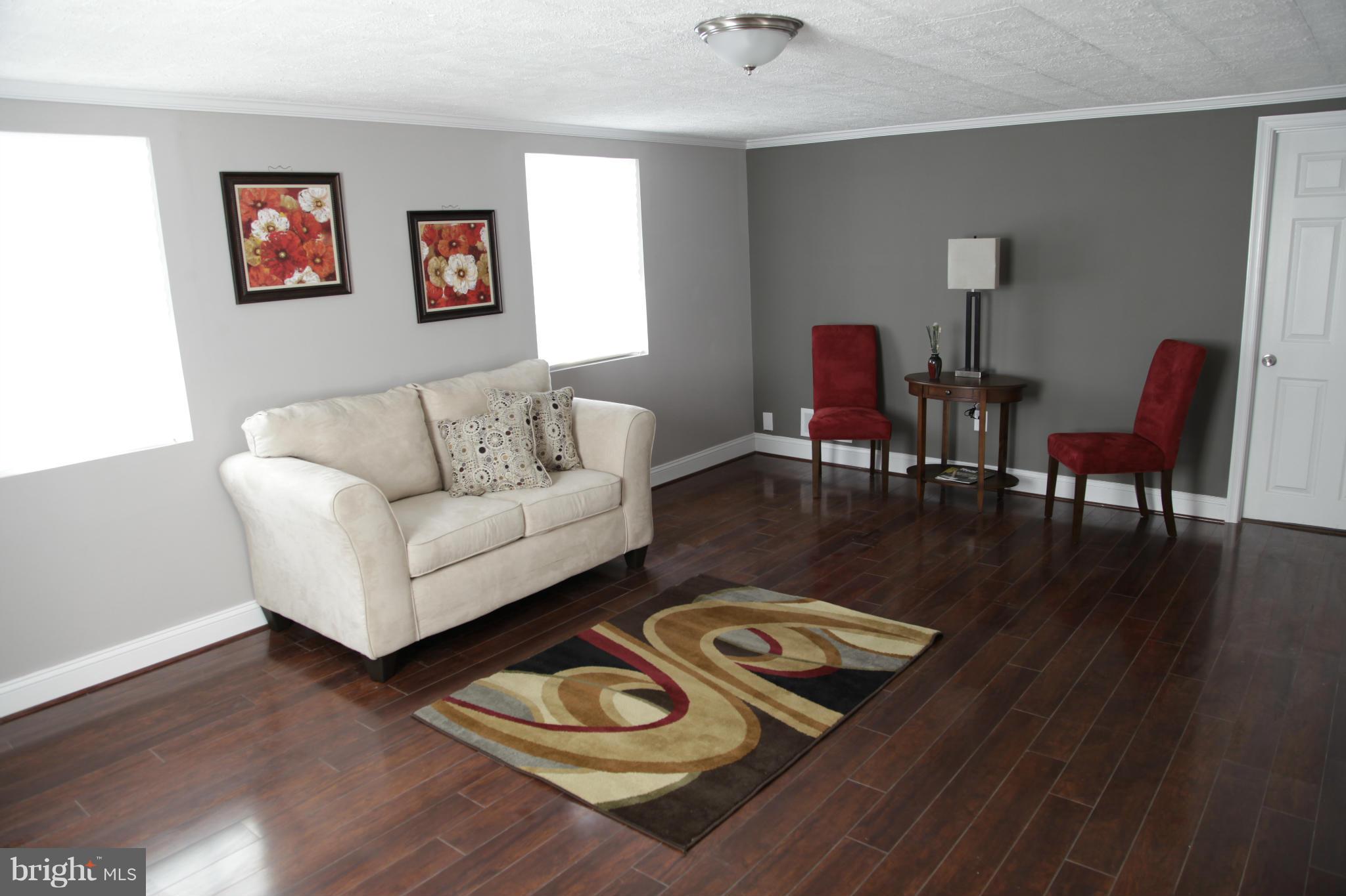 3344 Ripple Road Windsor Mill, MD 21244 - Photo 24 of 30 a living room with furniture rug and wooden floor