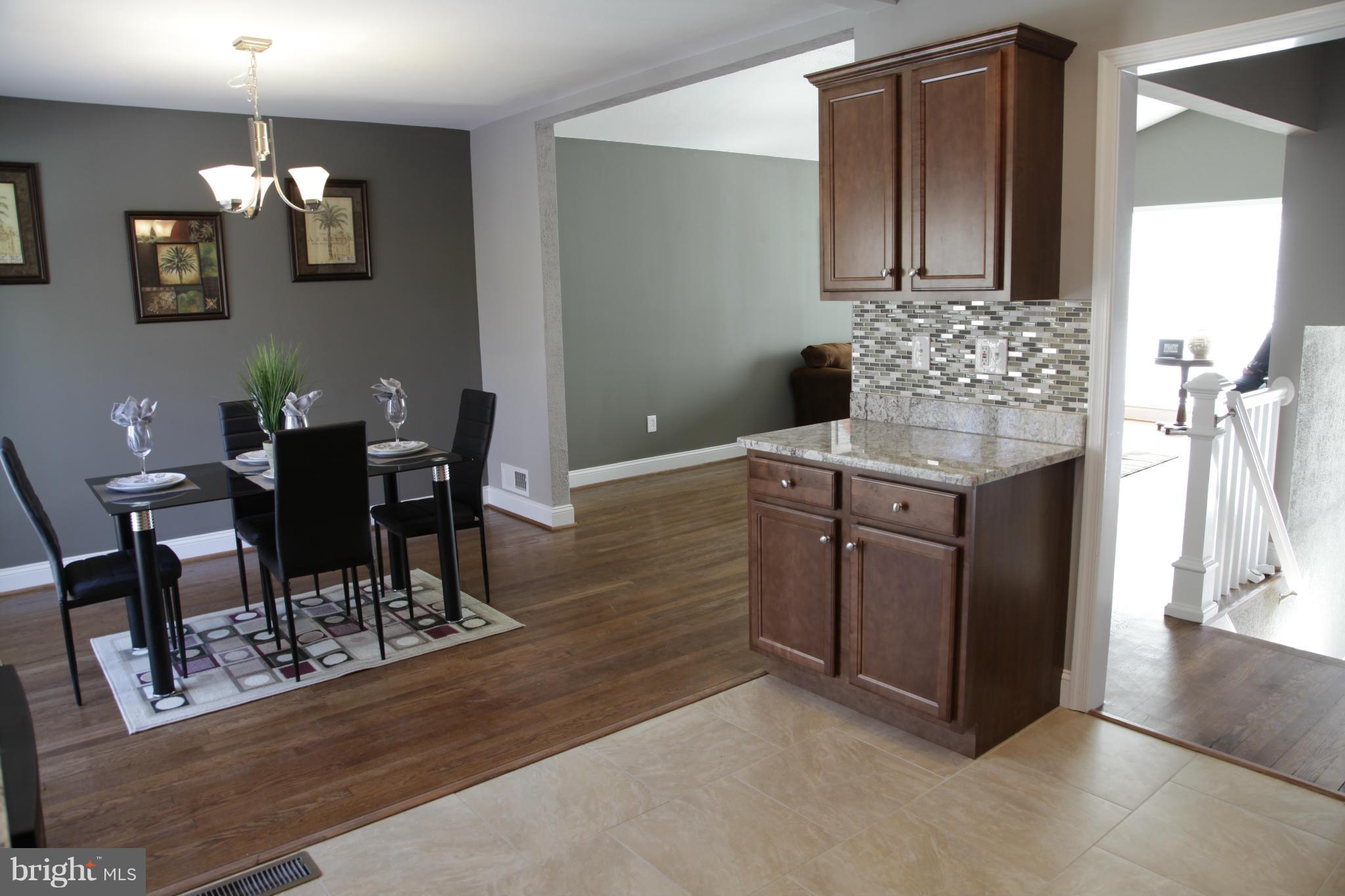 3344 Ripple Road Windsor Mill, MD 21244 - Photo 6 of 30 a dining room with granite countertop furniture and wooden floor