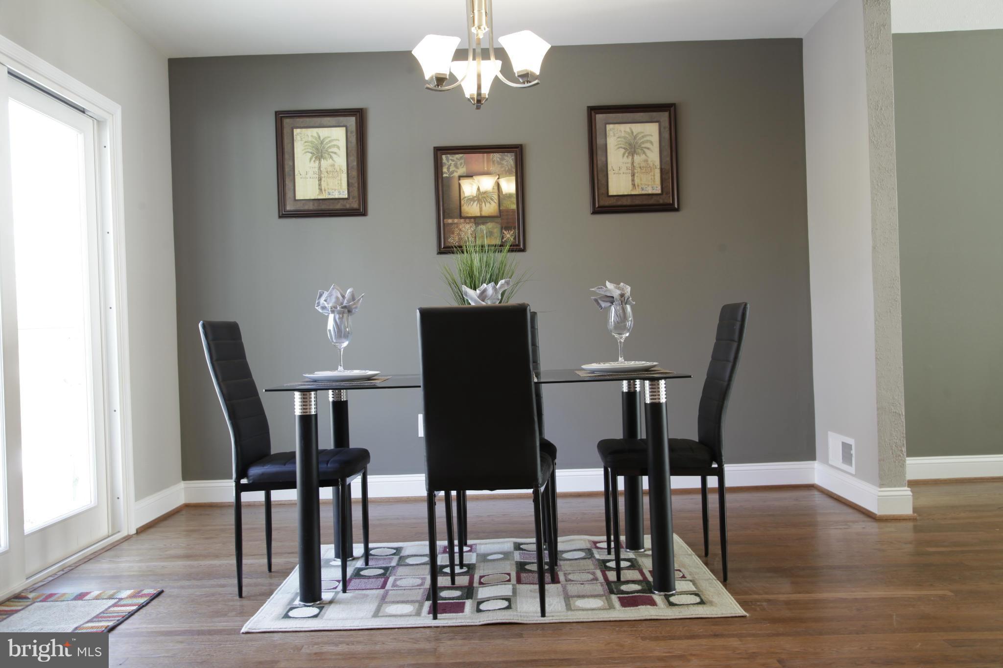 3344 Ripple Road Windsor Mill, MD 21244 - Photo 7 of 30 a view of a dining room with furniture wooden floor and a chandelier