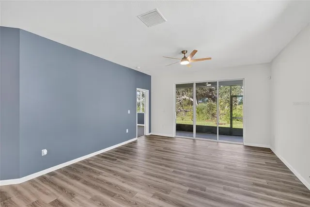 a kitchen with a sink cabinets and wooden floor