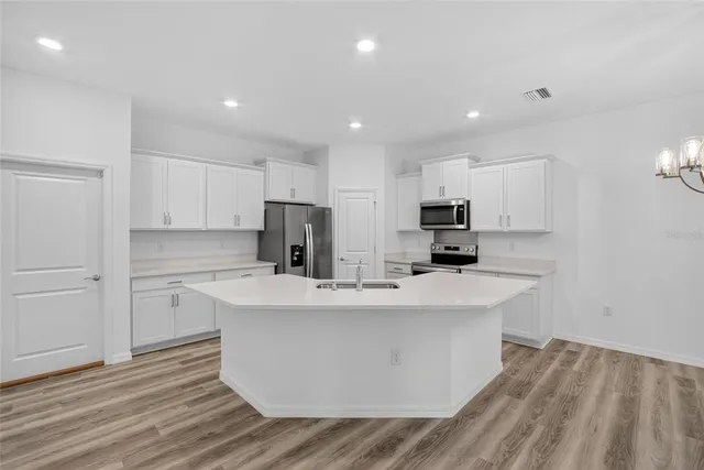 a view of a livingroom with a hardwood floor and a ceiling fan