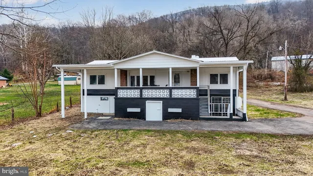 a front view of a house with a yard table and chairs