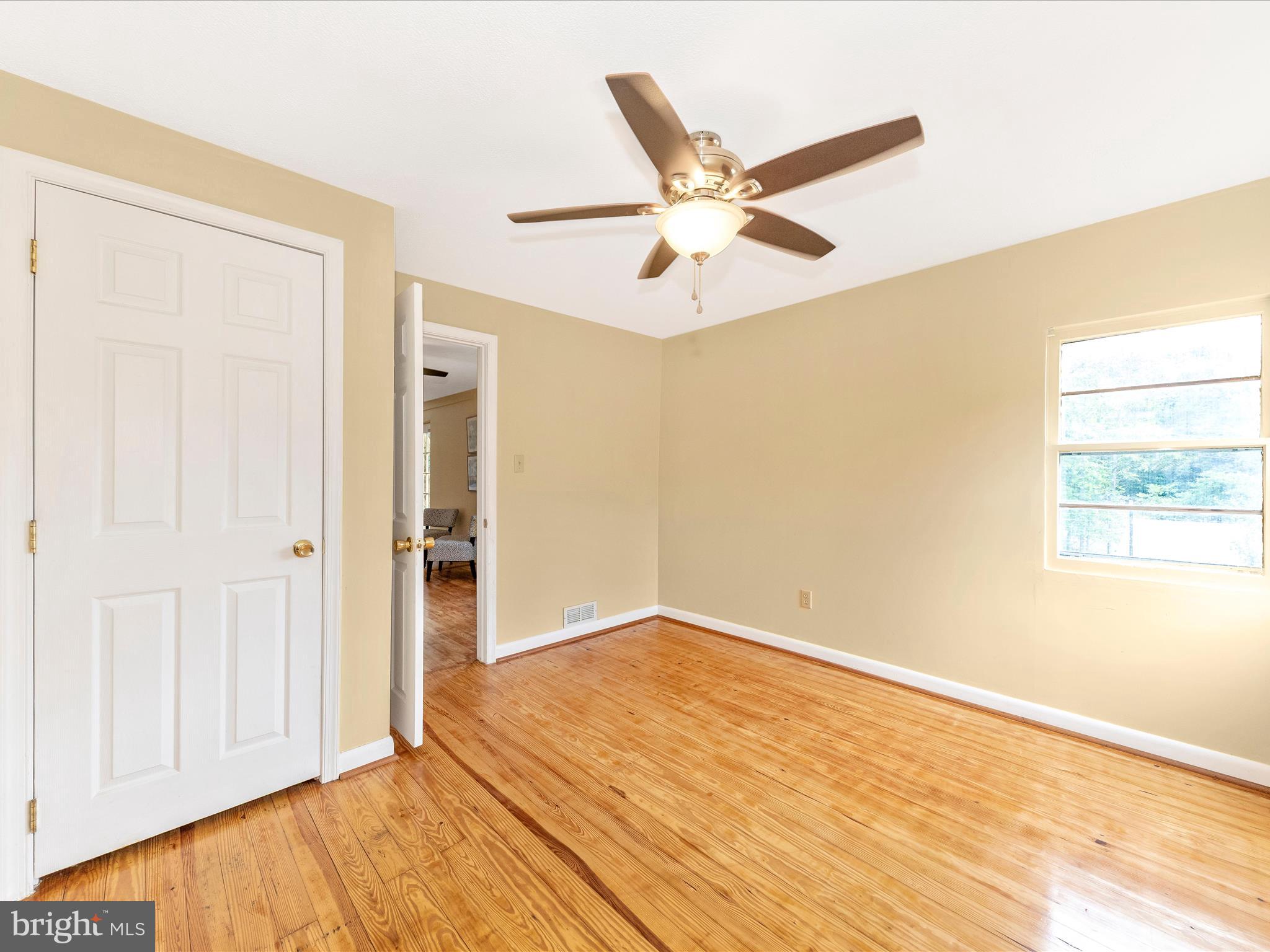 6 Myers Trail Berkeley Springs, WV 25411 - Photo 18 of 39 an empty room with wooden floor closet and windows