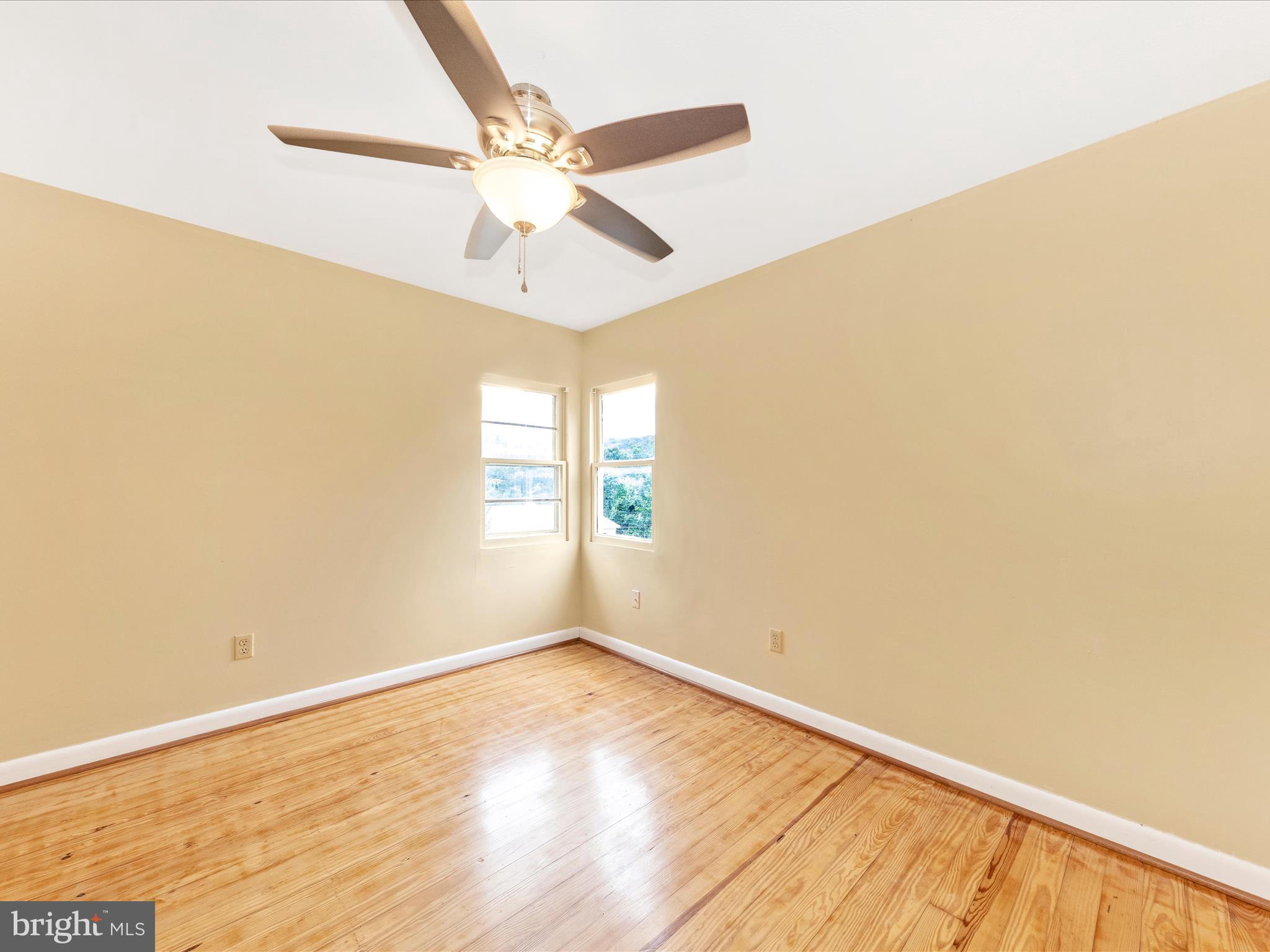 6 Myers Trail Berkeley Springs, WV 25411 - Photo 19 of 39 an empty room with wooden floor fan and windows