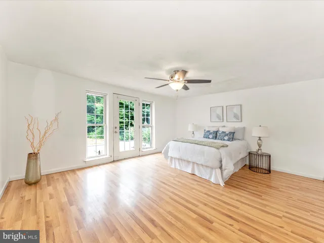 a spacious bedroom with a bed and a large window